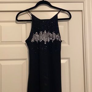 Very elegant, beaded, long black dress.
